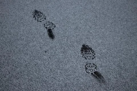 Footprints in the snow-covered parking lot Stock Photos