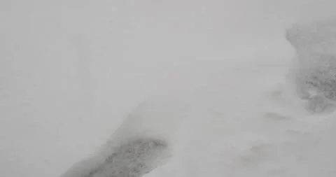 Footprints in the snow during winter storm close up of footprint Video stock 232445613
