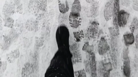 Footprints in the snow on the ground of a sidewalk Stock Footage 293510328