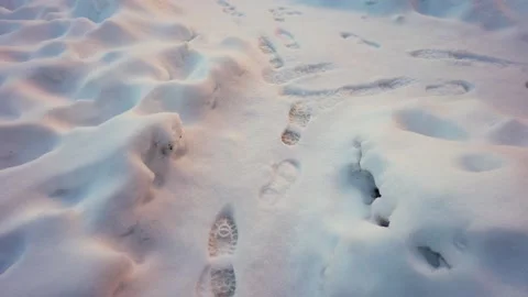 Footprints on the snow trail passes a fork. Clean and frosty daytime. Stock Footage 145574898