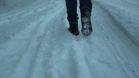 Footprints on a snowy road. 스톡 동영상 168748679