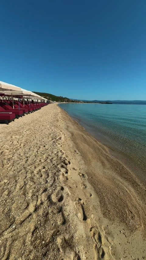 Footprints trace a path from shore to sea. Trani Ammouda, Greece. Vertical Stock Footage 339628940