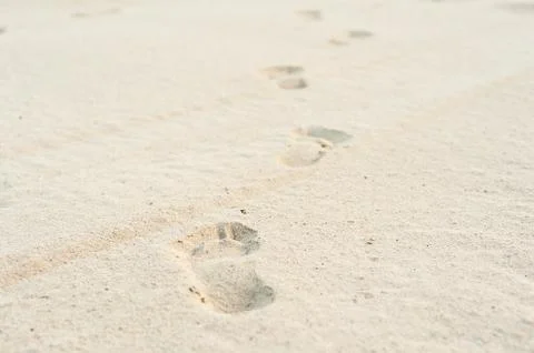 Footprints on white sand Stock Photos
