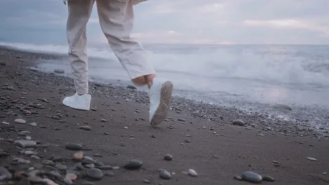 Footsteps along the stone seashore Stock Footage 220356583