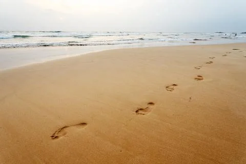 Footsteps on the beach, background Stock Photos