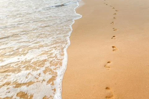 Footsteps on the beach Stock Photos