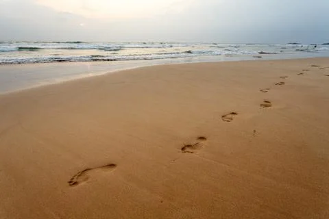 Footsteps on the beach Stock Photos