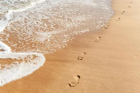 Footsteps on the beach Stock Photos