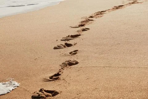 Footsteps on the beach Stock Photos