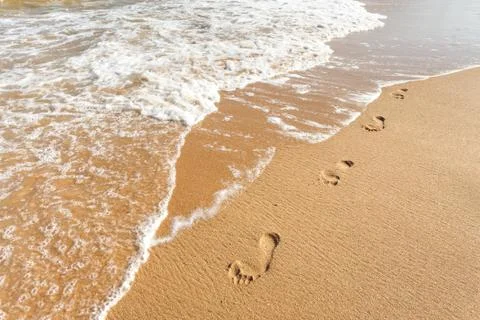 Footsteps on the beach Stock Photos