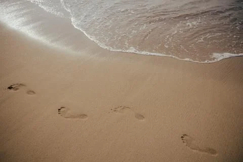 Footsteps on the beach Stock Photos