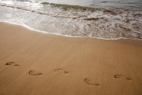 Footsteps on the beach Stock Photos