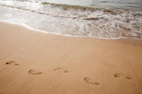 Footsteps on the beach Stock Photos