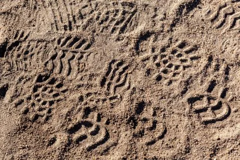 Footsteps on ground - pattern people marks Stock Photos