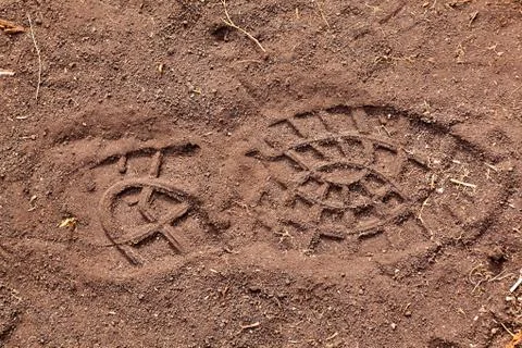 Footsteps on ground - pattern people marks Stock Photos