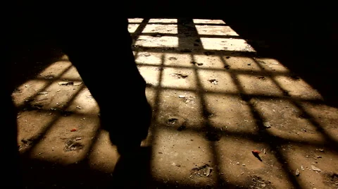 Footsteps of a man walking away in a scary,dark room Stock Footage