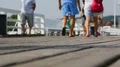 Footsteps of people strolling along old wooden pier, enjoying beauty of sea HD Footage