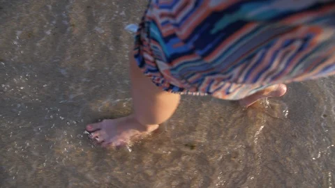Footsteps on Sandy Beach with Sea Waves on Coast. Young Woman in Sundress. Stock Footage 94496982