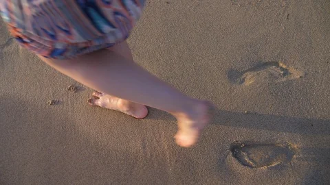 Footsteps on Sandy Beach with Sea Waves on Coast. Young Woman on Sand. Stock Footage 94497434