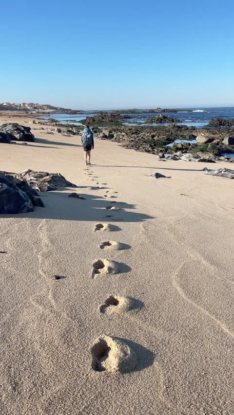 Footsteps on sandy low-tide sandy wide, long beach while Shot during the Camino Stock-Footage 334328164