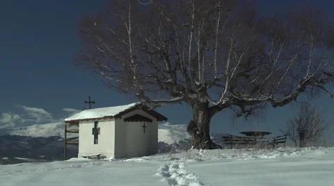 Footsteps in the Snow Mountain Church Tree 4K Stock Footage 59771752