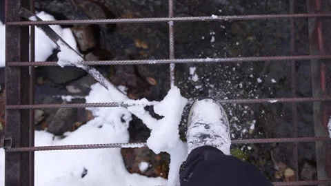Footsteps on a snowy bridge over a stream in the forest Stock Footage 310230957