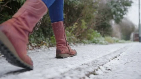 Footsteps walking on freshly snowy footpath. Stock Footage