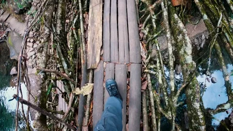 Footsteps walking on a living root bridge over river in Meghalaya, India Video stock 258372768