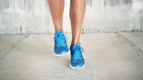 Footwork of athletic male doing jump rope excercise in industrial building Video stock 112653384