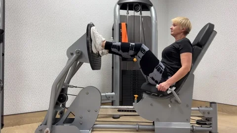 Footwork video of leg press hamstring training. Purposeful woman working on Stock Footage 265903795
