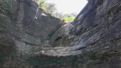 Foradada cliff hole stone rock gorge mountain pass ravine day sunlight valley Stock Footage 329768424