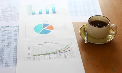 Forcasting and analyzing incomes charts and graphs report with coffee cup, Stock Photos