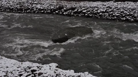 Forceful water course rushing beyond jet black stones and icy cliffs 스톡 동영상 333333891