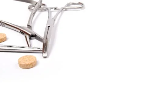 Forceps and pills Stock Photos