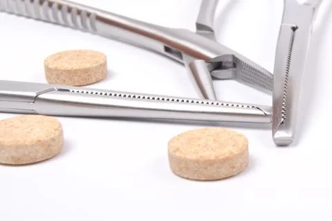 Forceps and tablets Stock Photos