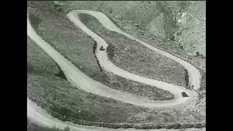 A Ford Model T is driven through a tunneled Sequoia tree as families travel to Video stock 118650445