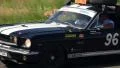Ford Mustang Fastback with two spare wheels on roof taking part in rally HD Footage
