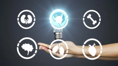 Forearm entering right and holding palm, bringing glowing brain bulb, lighting Stock Footage 328685331