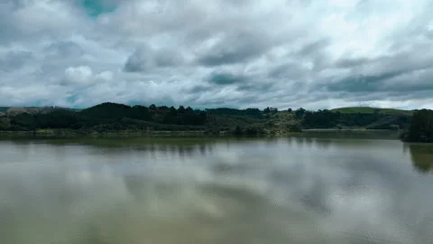 Foreboding clouds float over tranquil seas at Ohiwa Harbour - New Zealand 動画素材 176767511