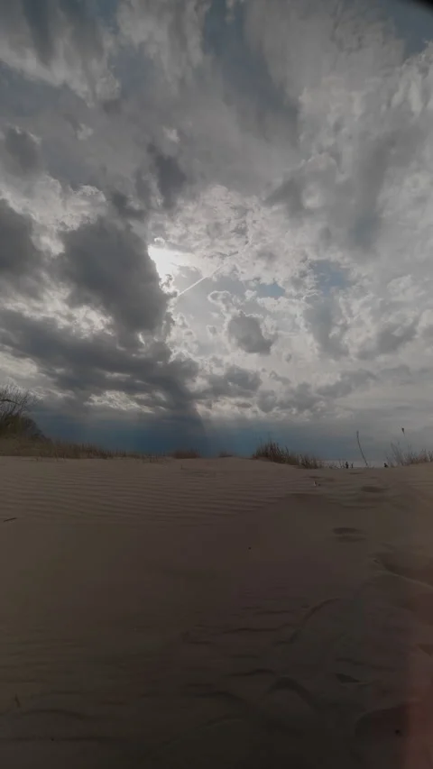 Foreboding sky casting shadows across windswept desert landscape at sunrise Stock Footage 334012453
