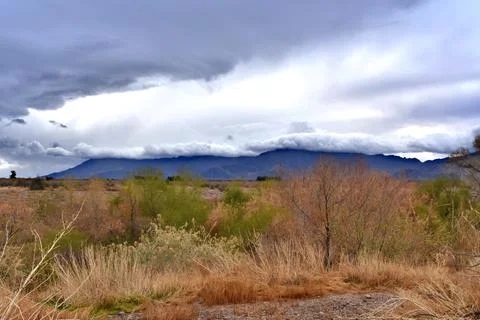 Foreboding storm clouds over a mountain top. Stock Photos