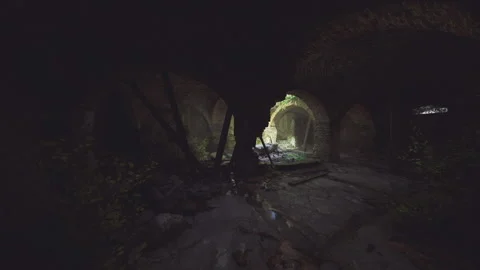 Foreboding underground hallway with shadowy shapes and damp uneven stones Stock Footage 341830438