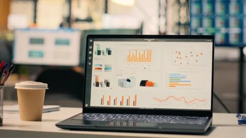 Forecasting reports running on laptop screen in empty business office Stock Photos