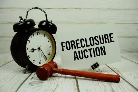 Foreclosure Auction text message on paper card with wooden gavel and alarm .. 写真素材
