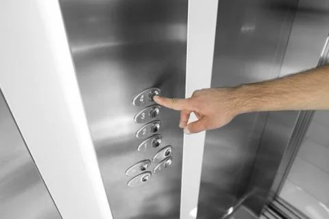 Forefinger pressing the fourth floor button in the elevator. Foto stock