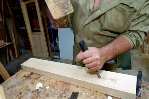 Forefront of the hands of a carpenter working. Фото