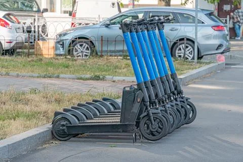 Foreground features an array of blue metallic cylindrical tubes, arranged i.. Stock Photos