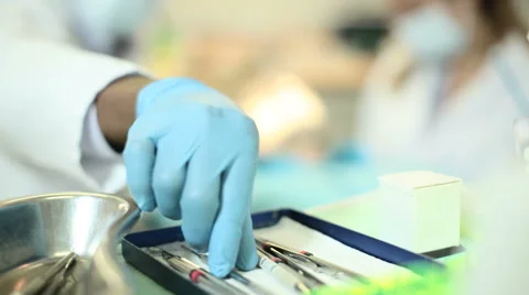 Foreground focus on dental instruments during examination Stock Footage 54237327