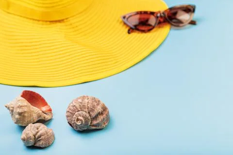 In the foreground in the focus of the shells, in the background a yellow hat and Stock Photos