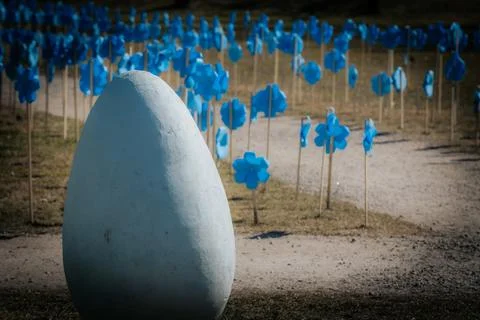 In the foreground, a large white decorative Easter egg with. Stock Photos